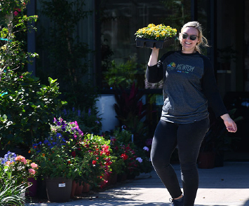 A Girl Smiling And Carrying Flowers